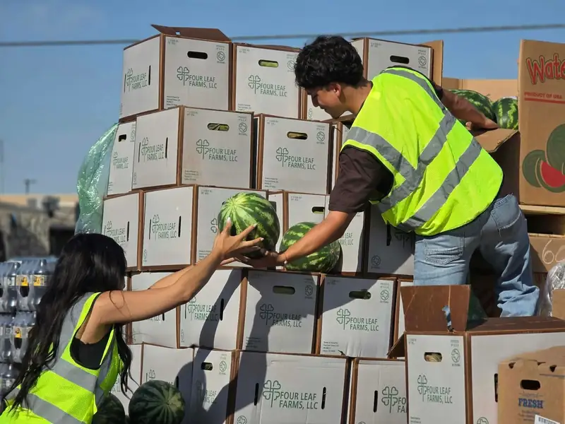 Volunteers unloading watermelons for the food drive