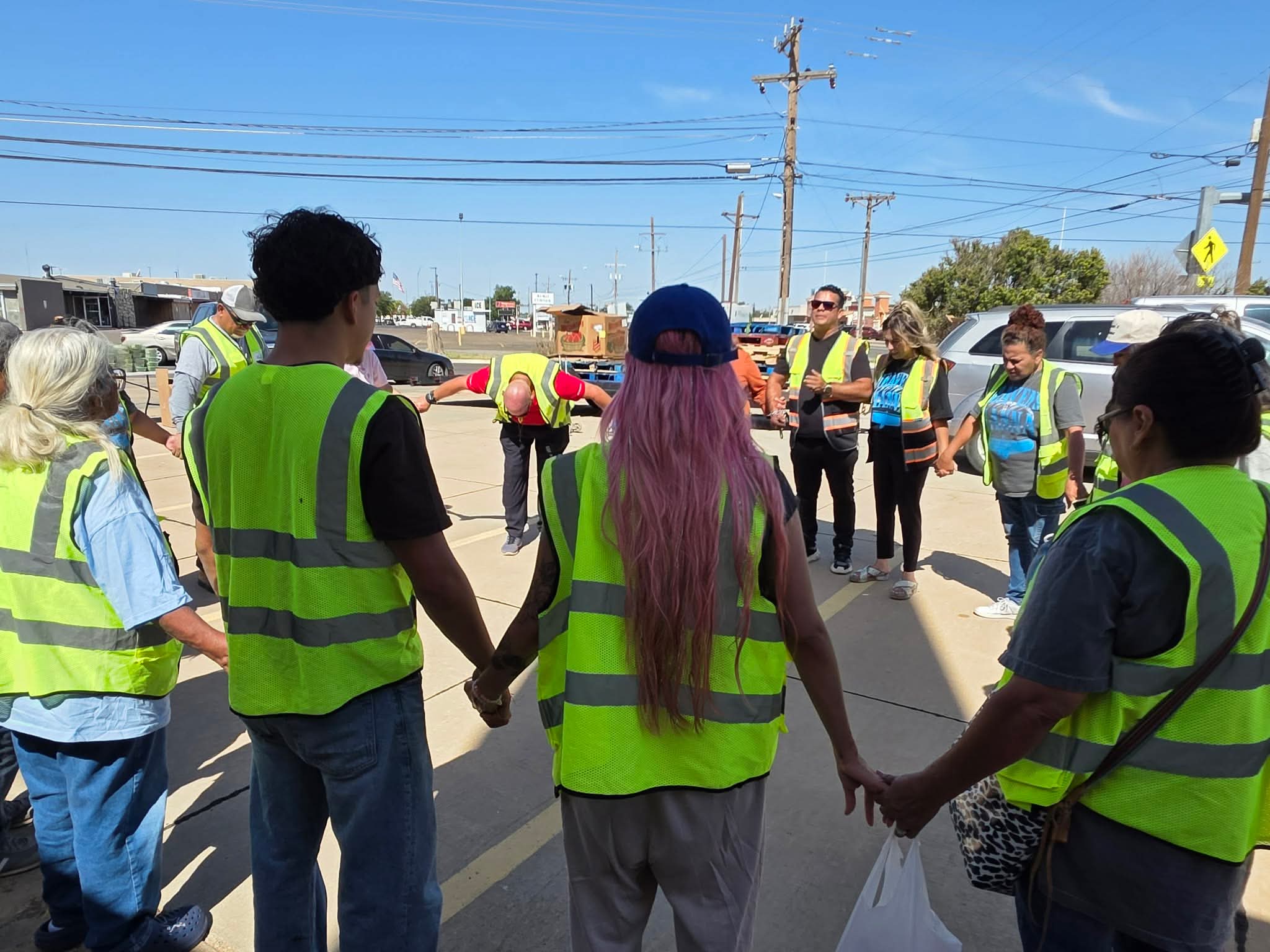 Heaven's Mana volunteers praying together in a circle