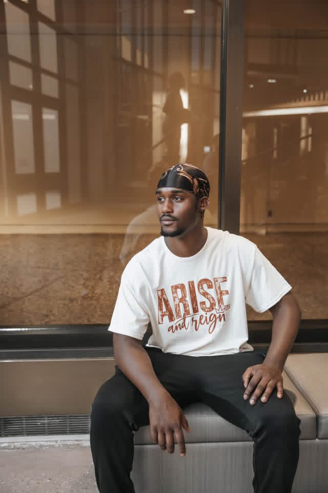 A member wearing the Arise and Reign t-shirt
